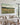 Wildflower meadow canvas with Psalm 46:10 text displayed above a linen sofa in a modern farmhouse living room