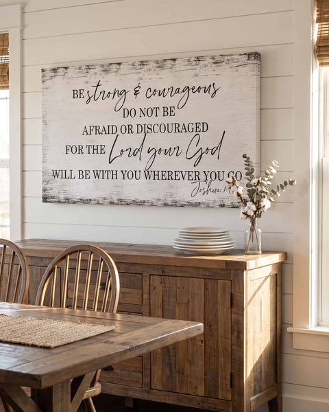 Joshua 1:9 canvas hanging above a farmhouse dining room sideboard