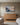 Misty bay rowboat painting-style canvas with Cast All Your Anxiety on Him above an oak dresser in a children's bedroom