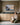 Woman folding linen towels looks up at a 1 Peter 5:7 painting-style canvas in a laundry room by the back door