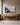 Large 48 x 32 inch Cast All Your Anxiety on Him painting-style canvas above an oak welcome table in a church foyer