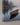 Close-up of the gallery-wrapped corner of the painting-style canvas showing the wooden rowboat and pine reflections