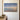 Footprints in the Sand painting-style canvas with a beach sunrise and the full poem, hanging on an ivory plaster wall above a walnut console