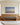 48 x 32 inch Footprints in the Sand painting-style canvas above a long oak bench in a residence family lounge