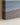 Close-up of the lower corner of the gallery-wrapped painting-style canvas showing footprints in wet sand and the printed edge