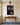 Jesus crown of thorns and empty tomb canvas over a cherry console table in an entry hall with a brass lantern