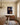 Deep blue canvas of Jesus with Golgotha and the resurrection hidden in his portrait above a walnut sideboard in a formal dining room