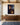 Large 32 x 48 inch canvas of Jesus with Calvary and the empty tomb above a long walnut sideboard in a great room with oak beams