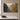 Painting-style apple orchard canvas with the Galatians 5:22-23 fruit of the Spirit verse, front view on a taupe plaster wall above a marble-topped console
