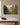 Painting-style apple orchard canvas with the Galatians 5:22-23 fruit of the Spirit verse, front view on a taupe plaster wall above a marble-topped console