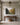 Fruit of the Spirit canvas wall art above a walnut console table in an entry hall with a brass lantern