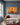 He Knows My Name canvas above an oatmeal linen sofa in a slate blue Georgian living room with tall sash windows
