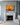 Good Shepherd canvas hung above a white Carrara marble fireplace on a grey-blue panelled chimney breast