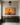 Christian canvas of Jesus among his flock above a walnut console in a limestone entry hall with olive wainscot
