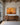 Large 48 x 32 inch canvas of Jesus with his hands on one sheep above a long walnut sideboard in a beamed Mediterranean great room
