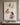 Canvas print of Jesus running to a lost lamb in the rain, kneeling to free it from a thornbush and holding it close, front view on a greige plaster wall
