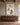 Large 32 x 48 inch canvas of Jesus and the lost lamb above a long walnut sideboard in a great room with oak beams