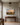 Small landscape canvas of an oak tree at sunrise above a walnut console in an upstairs hallway at the top of the stairs
