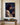 Oil-painting style canvas of Jesus in profile wearing the crown of thorns, one wrist in an iron shackle, front view on an ivory plaster wall