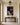 Crown of thorns Christian canvas over a walnut console table in an entry hall with a brass lantern