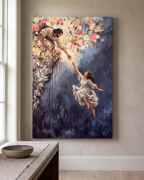 Portrait canvas print of Jesus kneeling on a flower-covered cliff and reaching down to a woman in a white dress, hung on a greige plaster wall