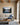 Lake and granite peak canvas with I will lift up mine eyes verse above an oatmeal linen sofa in a beamed living room