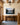 Pine-framed mountain lake canvas with Psalm 121 above a dark oak console in an oak-panelled entrance hall
