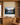 I will lift up mine eyes canvas between white oak built-in bookcases above a credenza in a study
