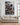 Canvas of Jesus guarding a lamb from wolves displayed above a linen sofa in a modern farmhouse living room with shiplap walls