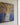Close-up of the gallery-wrapped canvas edge showing Jesus with clasped hands in a shaft of light beneath gold and amber leaves