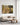 Canvas of a lamb running to Jesus on a clean white wall in a bright modern minimalist living room