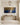 Wide Gethsemane canvas over a pale oak console in a panelled entry hall with a brass lantern