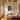 Christian wall art canvas hanging in an elegant living room with coffered ceiling and brass floor lamp