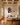 Christian wall art canvas hanging in an elegant living room with coffered ceiling and brass floor lamp
