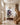Tall canvas artwork of Jesus protecting a lamb from wolves in a grand entryway foyer with chandelier and staircase