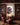 Dramatic canvas of Jesus and wolves hanging in a masculine wood-paneled home library with leather armchair