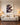 Canvas of Jesus protecting a lamb from wolves displayed above a cream sofa in a bright modern living room
