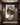 Jesus Lion of Judah canvas above a marble console table in a manor foyer, realistic scale away from the staircase