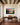 Mountain river sunset canvas with Mark 12:30 above a walnut writing desk under dark wood beams