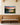 Large river sunset canvas with the greatest commandment above an oak pew bench in a church gathering room