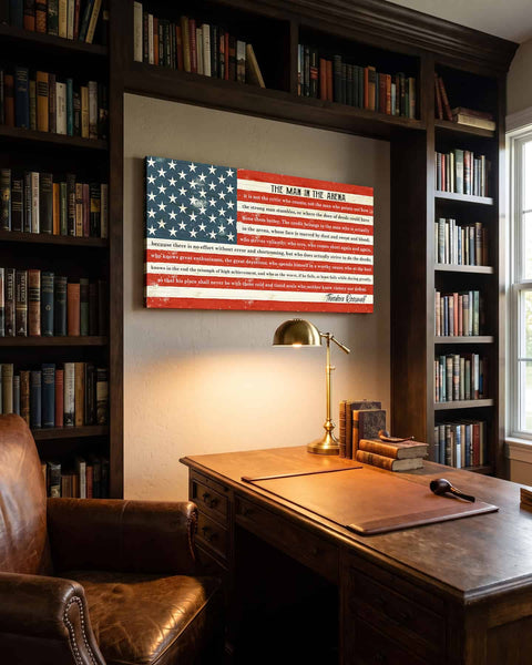 Man in the Arena canvas hanging above a wood desk in a home library