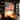 Man in the Arena canvas hanging above a wood desk in a home library