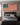 Man in the Arena American flag canvas hanging above a bed in a masculine bedroom