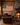 Man in the Arena American flag canvas hanging in a rustic log cabin living room by the fireplace