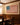 Man in the Arena canvas hanging in a traditional wood-paneled dining room