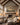 Framed Second Coming of Christ artwork over a stone fireplace in a vaulted great room