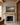 Hope and a future Bible verse canvas in a painted landscape style hanging over a limestone fireplace with an oak mantel