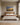 Painting-style canvas of a storm-lit grassland road with Jeremiah 29:11 centered above an upholstered headboard in a daylight bedroom