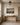 Small Jeremiah 29:11 painting-style canvas above an oak console table in a panelled upstairs hallway