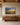 Large 48x32 painting-style canvas of a road through golden grassland with Jeremiah 29:11 above a long walnut sideboard in a great room